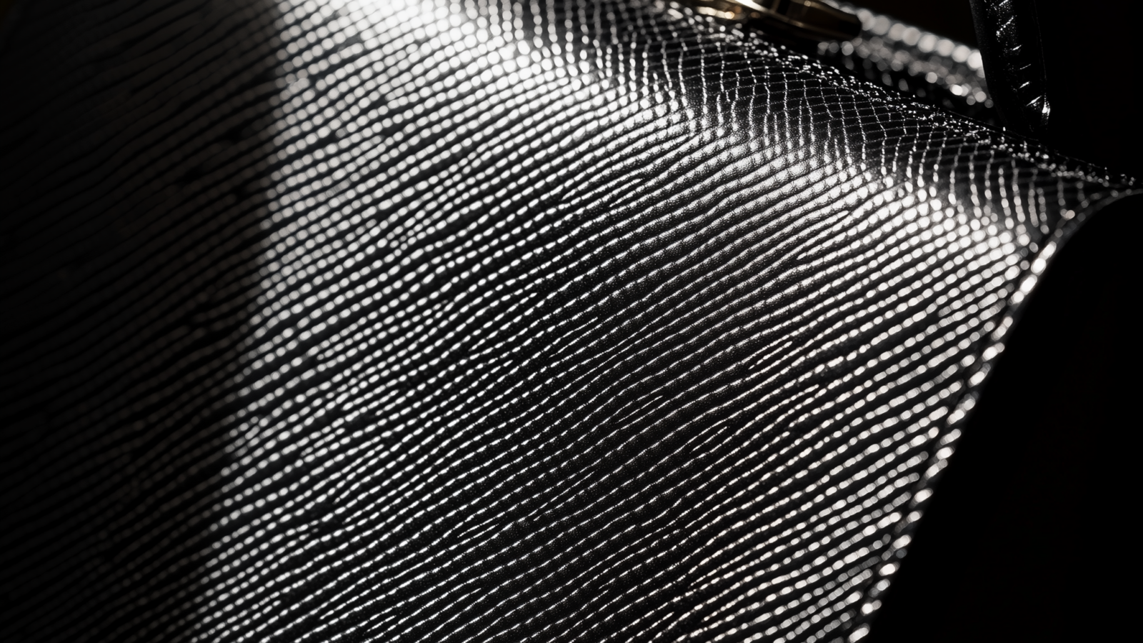 Saffiano leather handbag close-up showing the distinctive crosshatch texture and rigid structure
